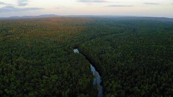 Aerial shot over Piscataquis River at Barrel Falls.