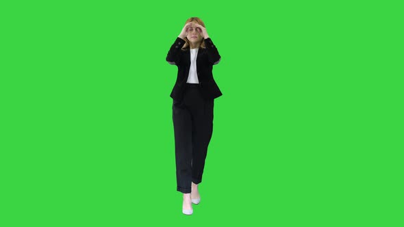 Blonde Business Woman Walking and Touching Her Hair on a Green Screen, Chroma Key.