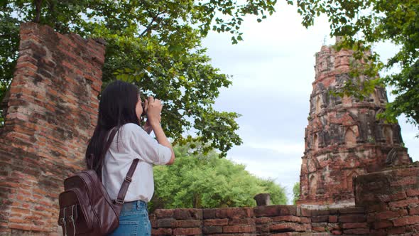 Japanese backpacker female enjoy her journey at amazing landmark in traditional city.