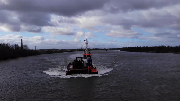 Dragger Crossing Oude Maas In Town Of Puttershoek, Netherlands. aerial drone pullback