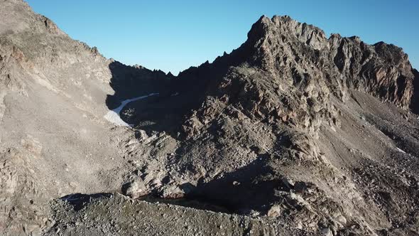 Mountain rocky summit in the alps, Switzerland. blue sky, snow, drone aerial view