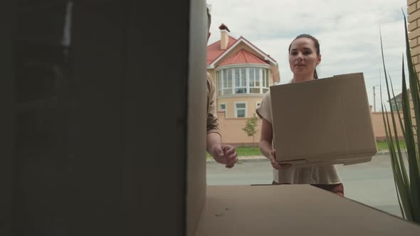 Couple Unpacking Car and Moving House