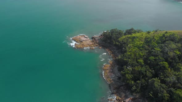 Flight over sea bay with rocks in Brazil