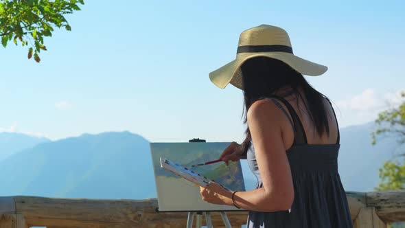 Woman Artist Painting From Nature