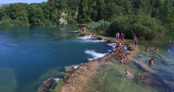 People having a good time and enjoying sunny day at river