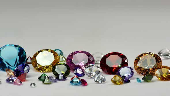 Colorful Diamonds Of Various Sizes Glittering On A White Background