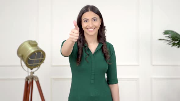 Happy Indian girl showing Thumbs up