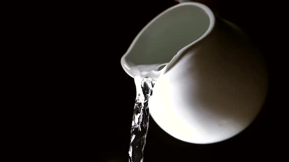 Pouring fresh clean water from a pitcher. The camera is flying. health and diet concept.