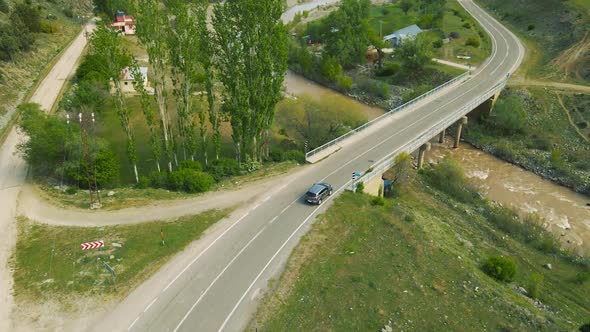 Top View of a Passenger Car That is Driving on a Mountain Road