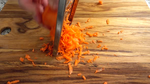 The Cook Rubs Carrots on a Grater 2