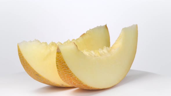 Melon slices rotating on white background
