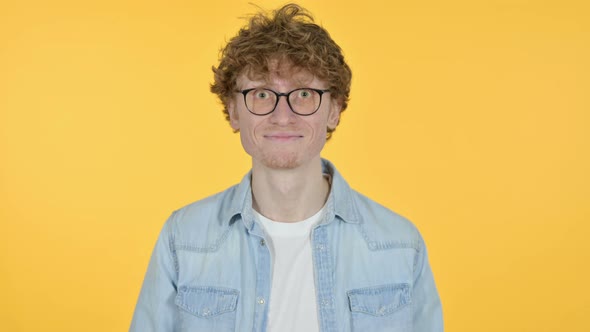 Redhead Young Man Yes By Head Shake, Yellow Background 