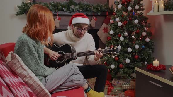 Young happy active family couple singing laughing together Christmas holiday.