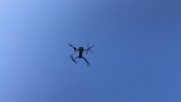 Drone Flying Against Blue Sky