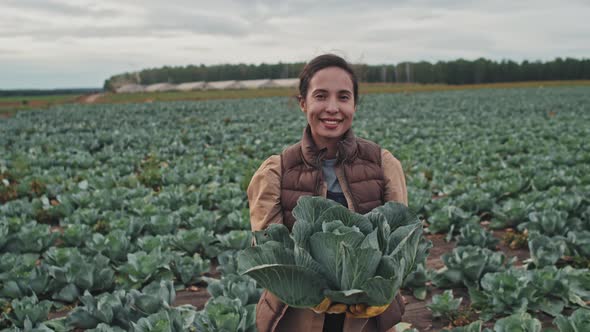 Female Farmer Holding Cabbage