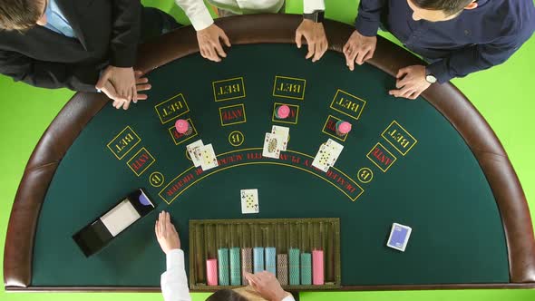 Players Play Poker in Casino at the Green Table. Green Screen. Top View