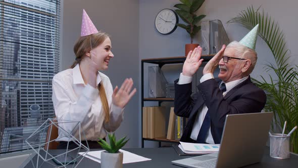 Two Joyful Collegues in Formal Suits Dancing Victory Dance Celebrating Success of Business Project