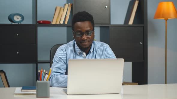 African American Businessman Using Laptop at Modern Office