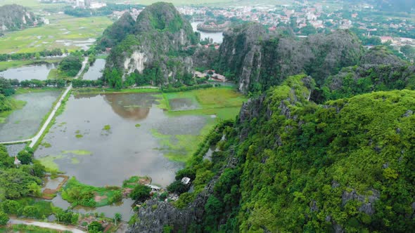 Aerial: North Vietnam karst landscape, drone view of Ninh Binh region, tourist destination