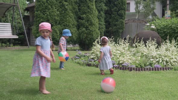 Happy Children Runing with MultiColor Beach Ball