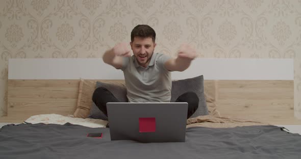 the Boy Looks at the Computer and is Happy