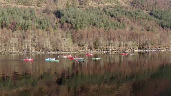 A Team of Canoeists Traversing a Lake in the Early Morning