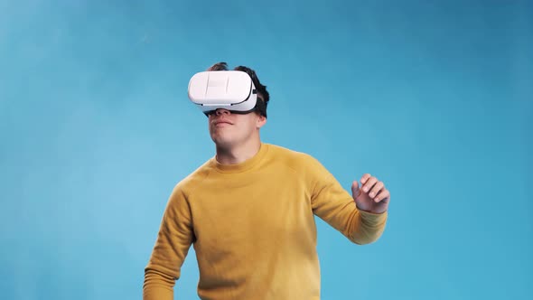 Man having fun while enjoying experiencing virtual reality with a VR headset.