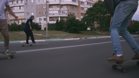 Group of Young People Skateboarding on the Road in the Early Morning Cinematic Shot Slow Motion