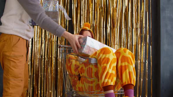 Sad Woman in Pajamas Sitting in Shopping Cart