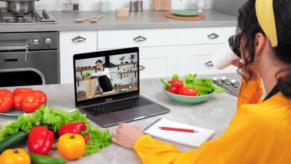 Woman in Kitchen Study Watch Online Cooking Lesson Listen Teacher Drinks Coffee