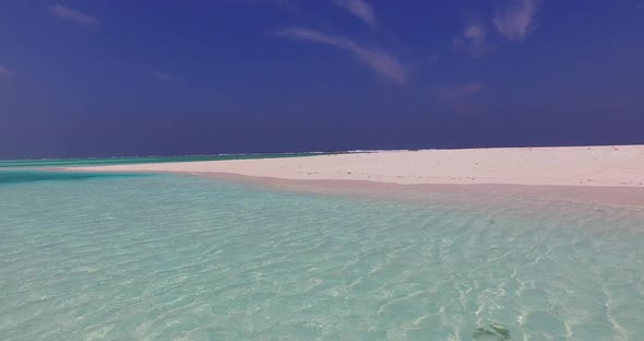 Natural fly over abstract view of a sunshine white sandy paradise beach and blue ocean background in