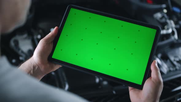 Mechanic Checking Car Using Tablet