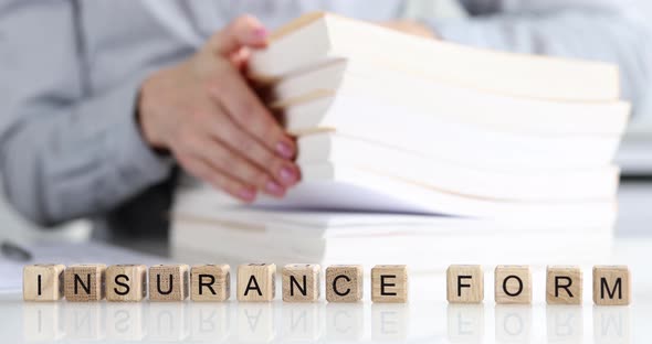 Person Examines Insurance Forms and Insurance Payments