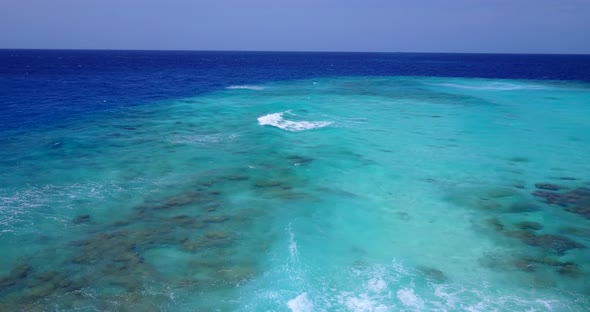 Wide aerial clean view of a sunshine white sandy paradise beach and blue ocean background in colorfu