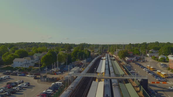 Forward Aerial Pan of Train Leaving the Station in Port Washington Long Island