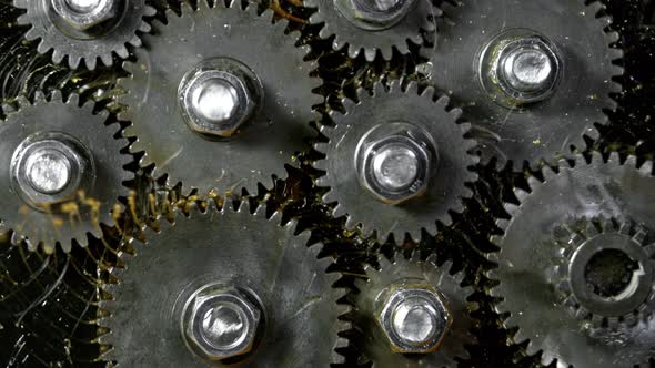 Super Slow Motion Shot of Gear Mechanism and Oil on Dark Background at 1000 Fps