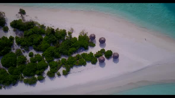 Aerial flying over texture of tropical coast beach holiday by blue lagoon with white sandy backgroun