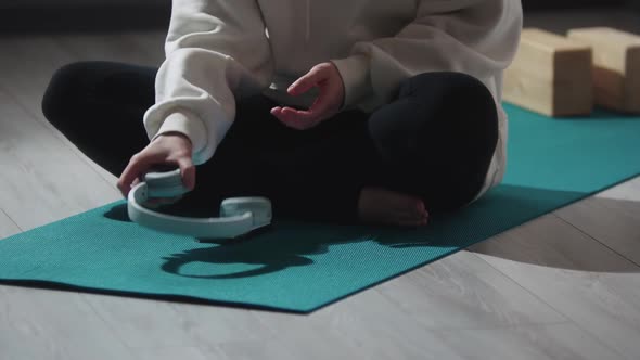 Muslim Woman Listening Music in Headphones