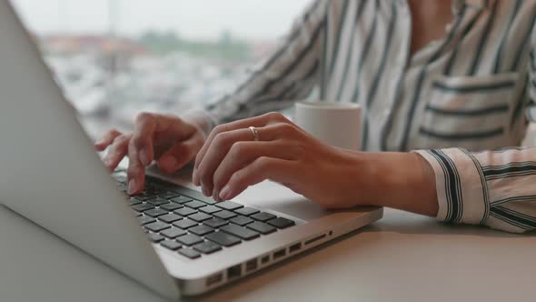 Business Woman Works with Laptop in Coworking Center