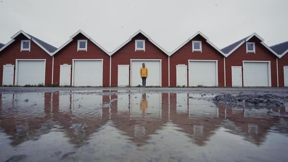 Man walking across similar small houses