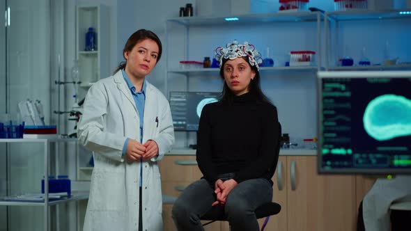 Researcher and Patient with Eeg Headset Looking at Virtual Display