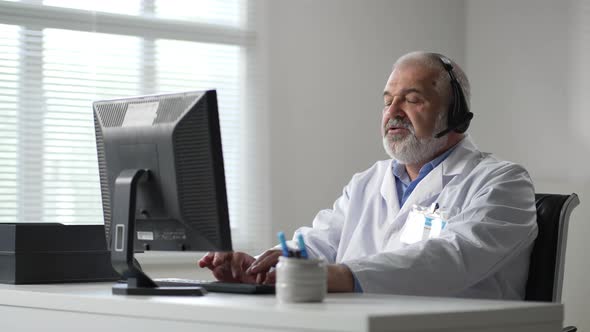 Sequence of Videos with Caucasian Male Doctor Sitting at Computer Screen and Talking to Sick Senior