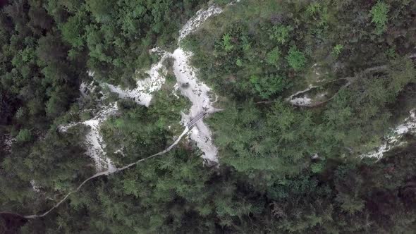 Aerial top view of Sugana Valley, with drone rotating while descending