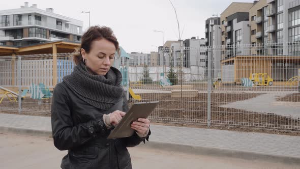 The Designer Girl Communicates with Her Client Using a Tablet.