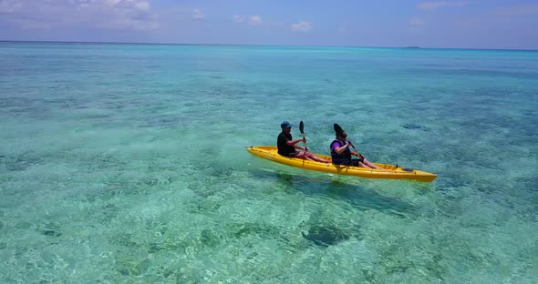 Young man and woman on romantic honeymoon have fun on beach on paradise white sand 4K background