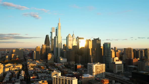 Rotating aerial drone view of the downtown Philadelphia skyline featuring tall, glass skyscrapers at