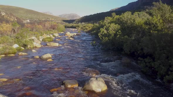 Aerial over a mountain stream in the countryside