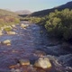Aerial over a mountain stream in the countryside - VideoHive Item for Sale