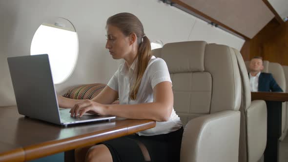 Portrait Young Woman Using Modern Smartphone and Laptop at Plane,