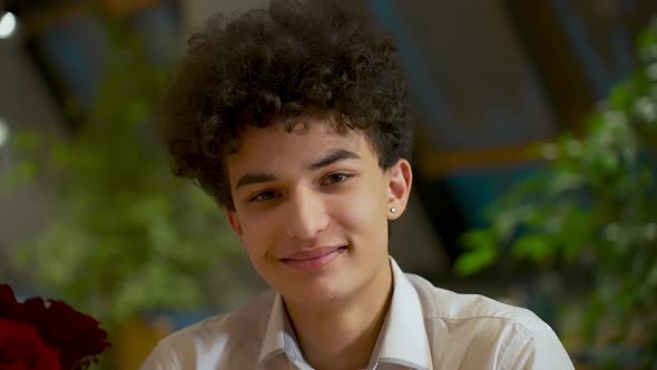 Closeup Portrait of a Young Handsome Guy Zoomer Mixed Race with an African Hairstyle Smiles and